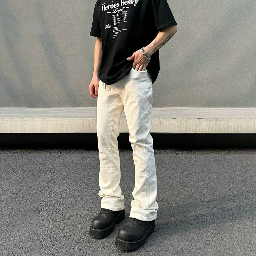 Men's off-white snap-hem utility flare jeans front full-body view featuring high-waisted streetwear fit and clean neutral denim