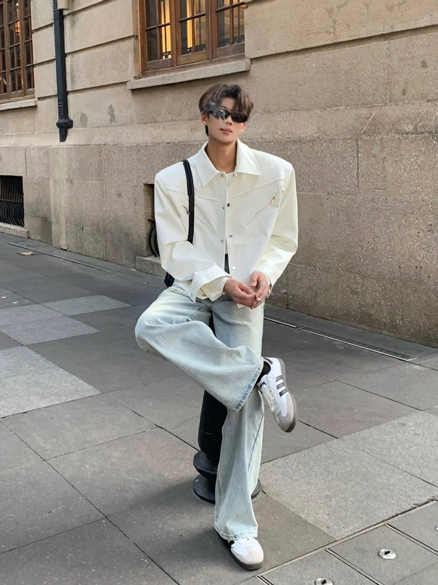 Off-white structured wide-shoulder cropped denim jacket shown from the front with button closure and subtle pocket details