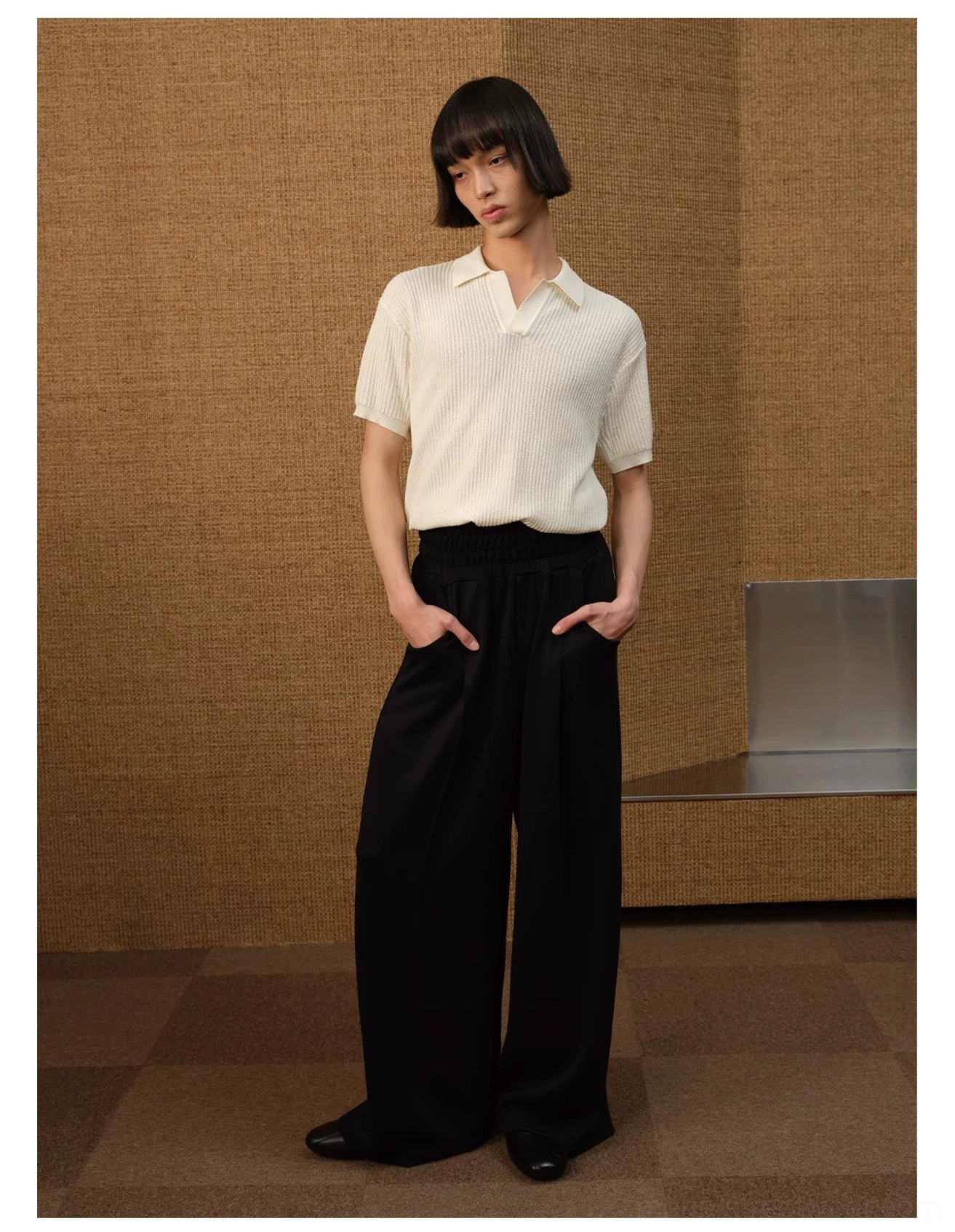 Off-white textured ribbed knit open-collar polo shirt styled with black wide-leg trousers and leather shoes