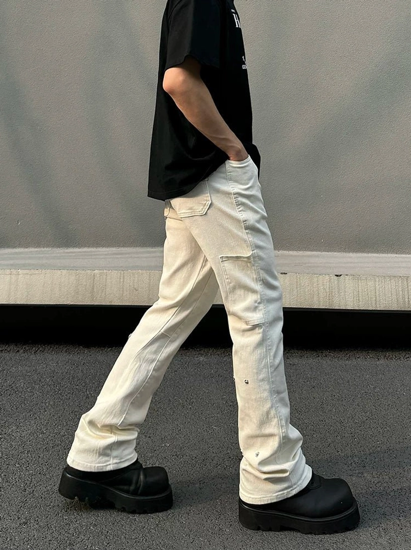 Men's off-white utility flare denim jeans side rear walking view showing bootcut leg shape and cargo-inspired thigh pocket