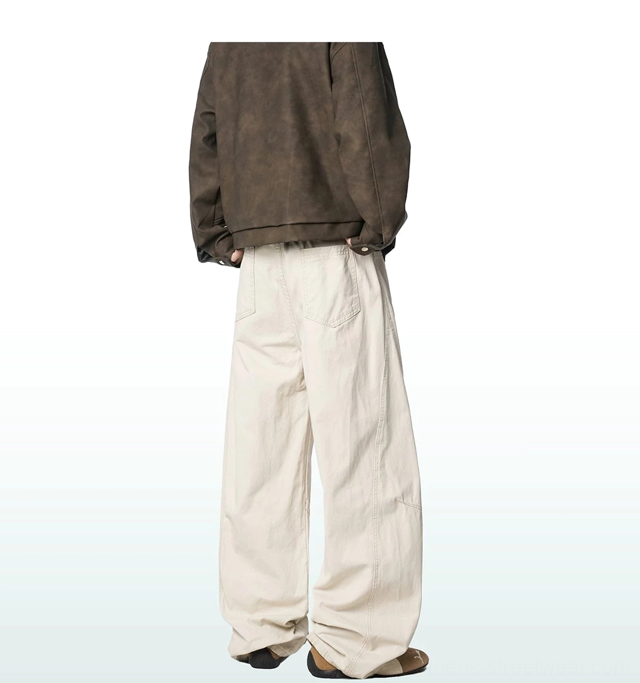Off-white wide-leg cargo trousers shown from the rear three-quarter angle, highlighting the back pocket details, heavy cotton canvas feel and loose fit