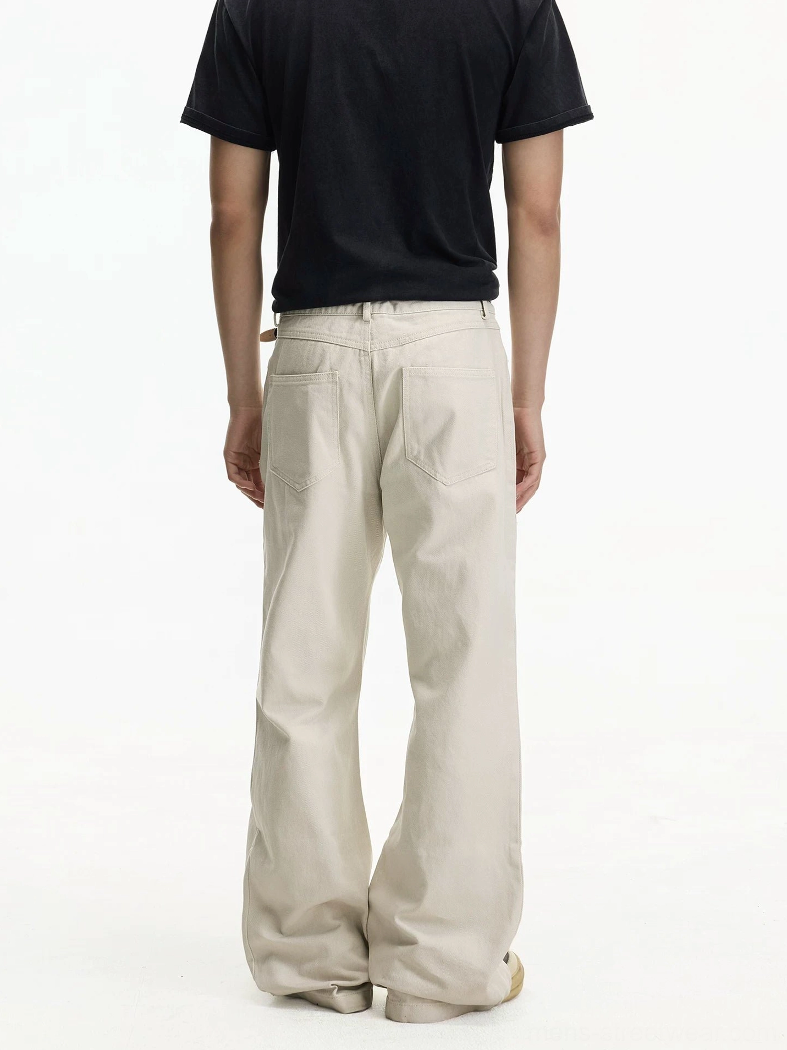 Back view of off-white wide leg jeans showing classic rear pockets and loose straight leg fit
