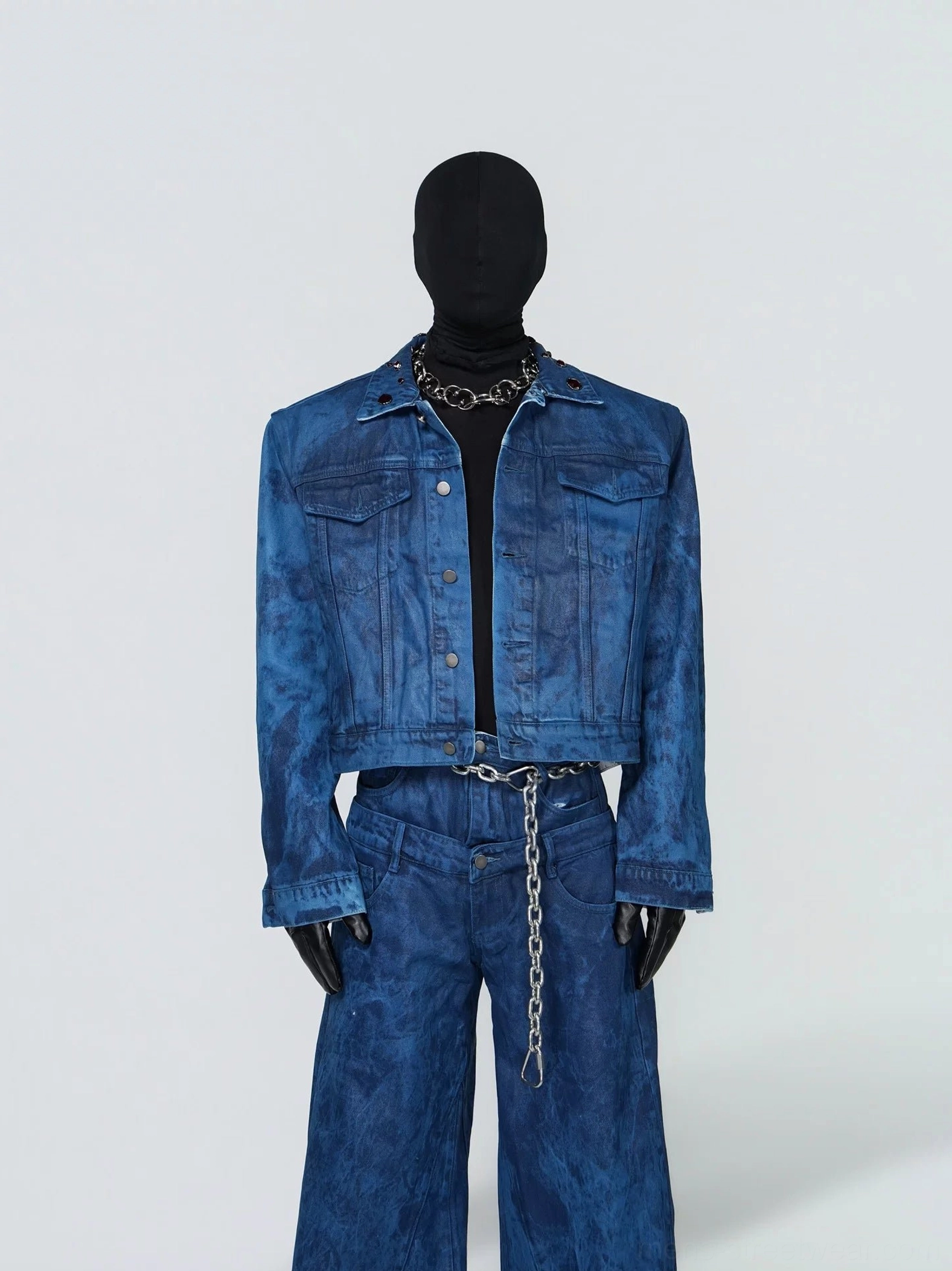 Front view of oil wax blue grommet collar cropped denim jacket with button closure, flap chest pockets, and boxy streetwear fit