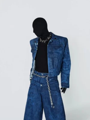 Side front view of oil wax blue cropped denim jacket with cloudy indigo wash, metal collar grommets, and matching denim streetwear styling