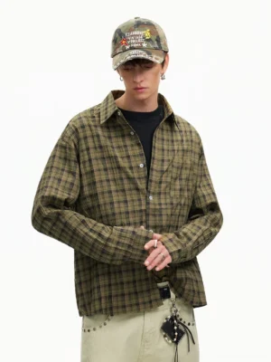 Olive green and brown oversized plaid flannel shirt styled with a relaxed fit chest pocket and casual layered streetwear silhouette