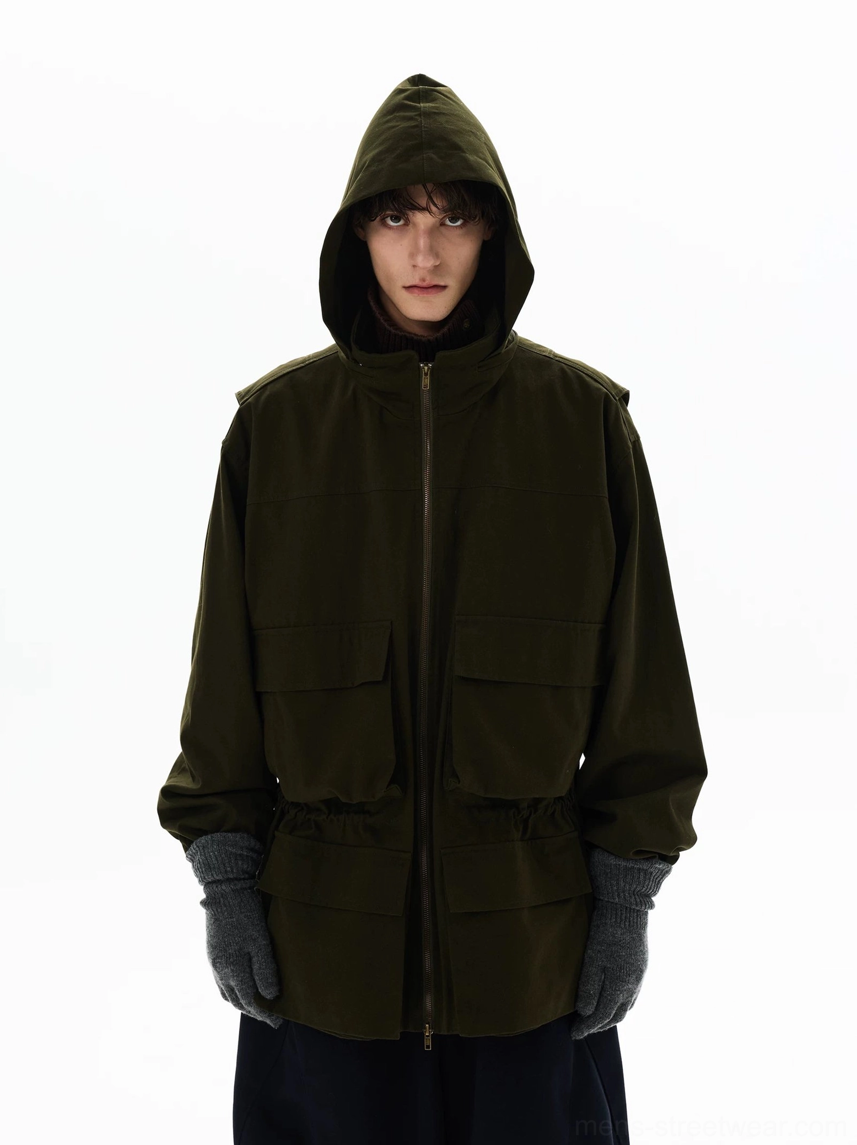 Olive green oversized hooded utility parka shown with full zipper, cargo pockets, heavy-duty outer fabric, and modern techwear styling