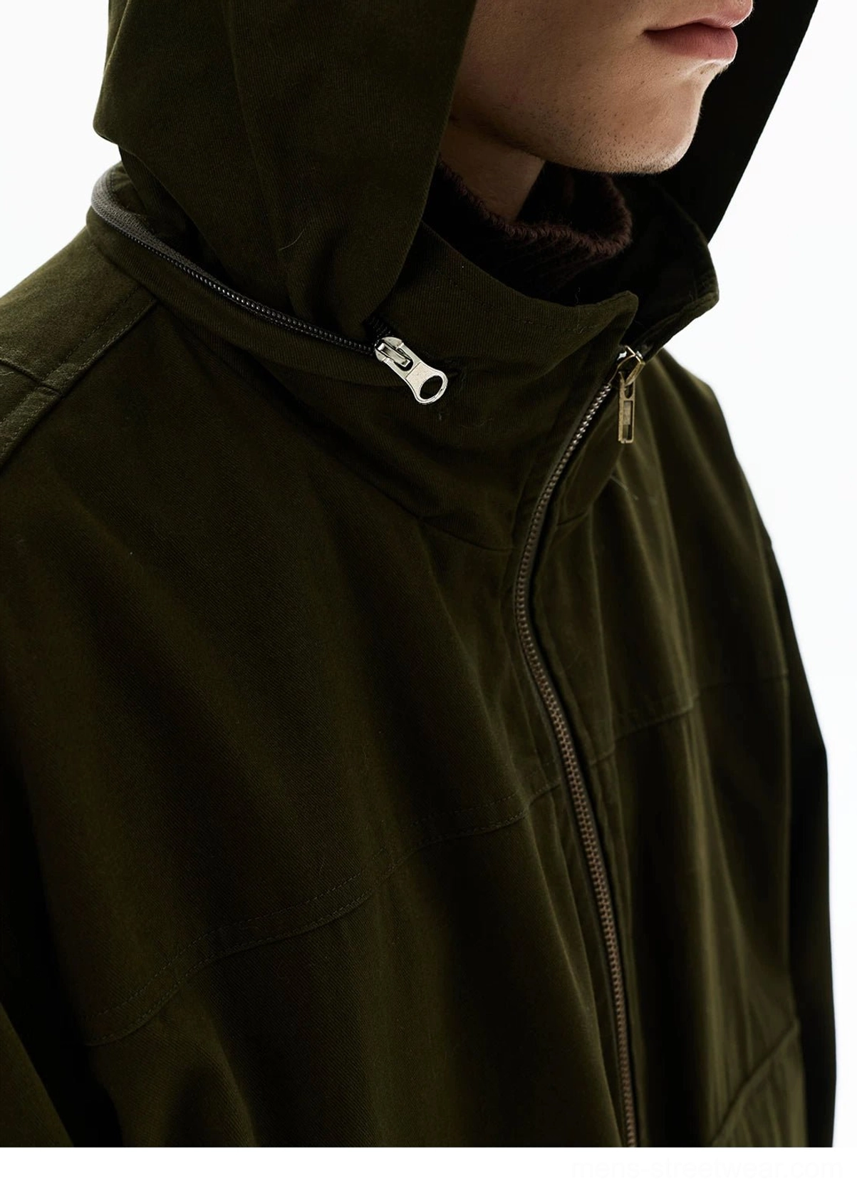 Olive green oversized utility zip parka product image featuring a high stand collar, functional pockets, and contemporary streetwear construction