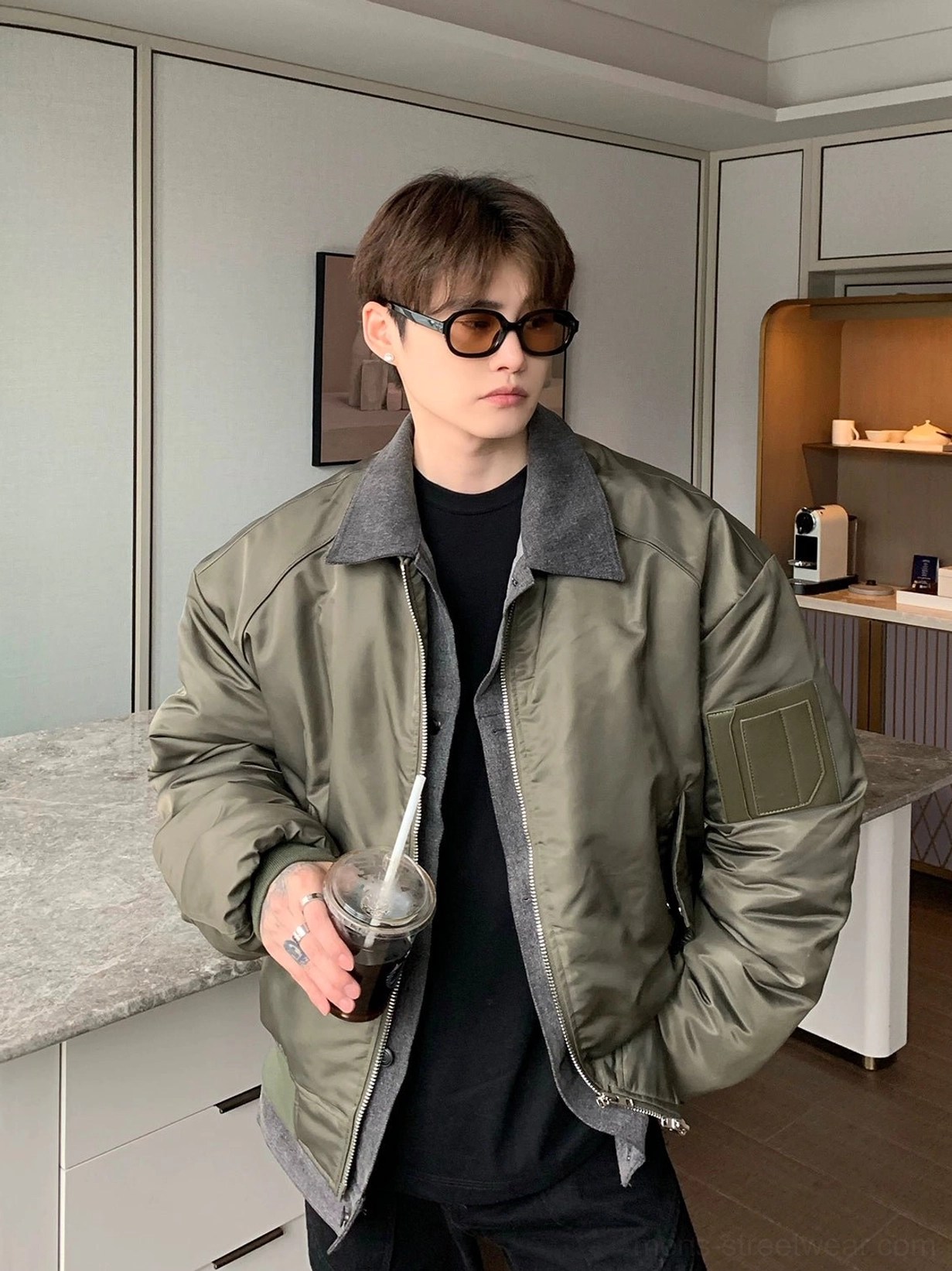 Olive green streetwear bomber jacket with full front zip grey contrast collar faux layered hem and oversized silhouette