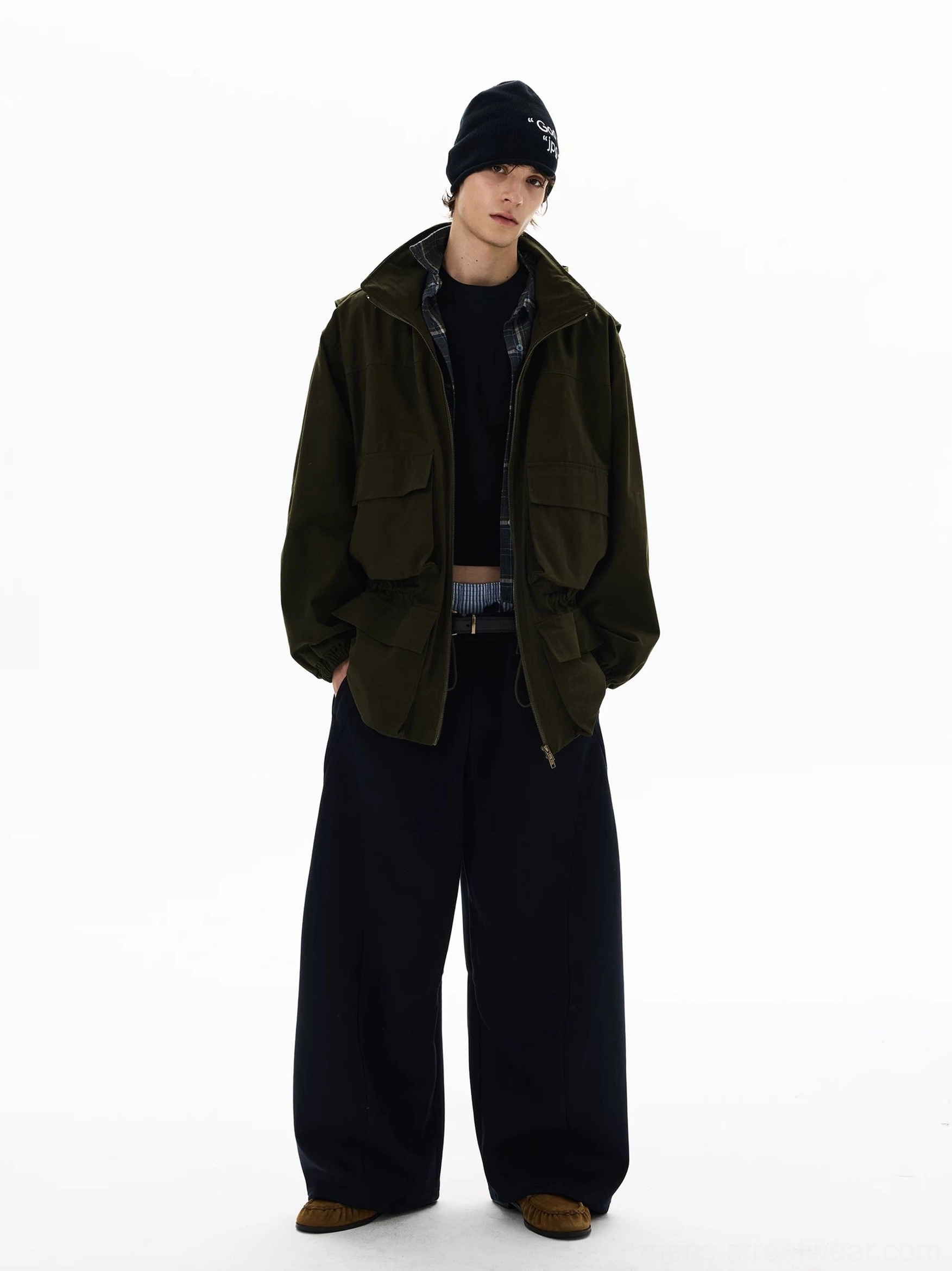 Front view of olive green utility parka styled with plaid layering, wide-leg dark trousers, and contemporary Seoul streetwear proportions