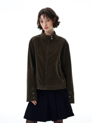 Olive green velvet faux suede stand collar moto jacket styled with a black pleated mini skirt