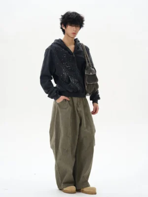 Male model wearing olive green wide-leg cargo pants with black hoodie and crossbody bag in Korean streetwear styling