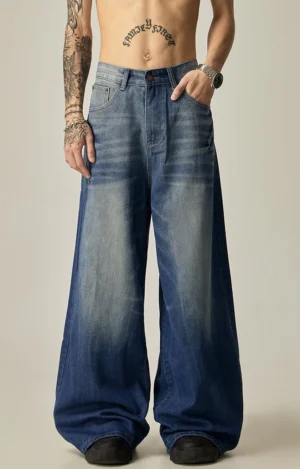 Front view of medium blue ombre fade ultra-wide leg vintage denim jeans styled with an oversized streetwear outfit