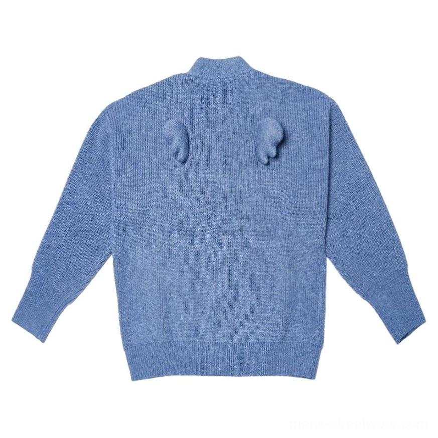 Oversized fuzzy cardigan available in Orange and Denim Blue with ribbed knit texture and distinctive wing pom-pom back detail