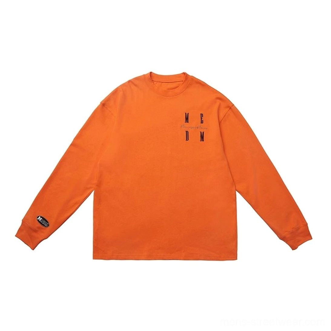 Bright orange oversized MCDM graphic long sleeve T-shirt flat lay with loose crew neck and small cuff tag
