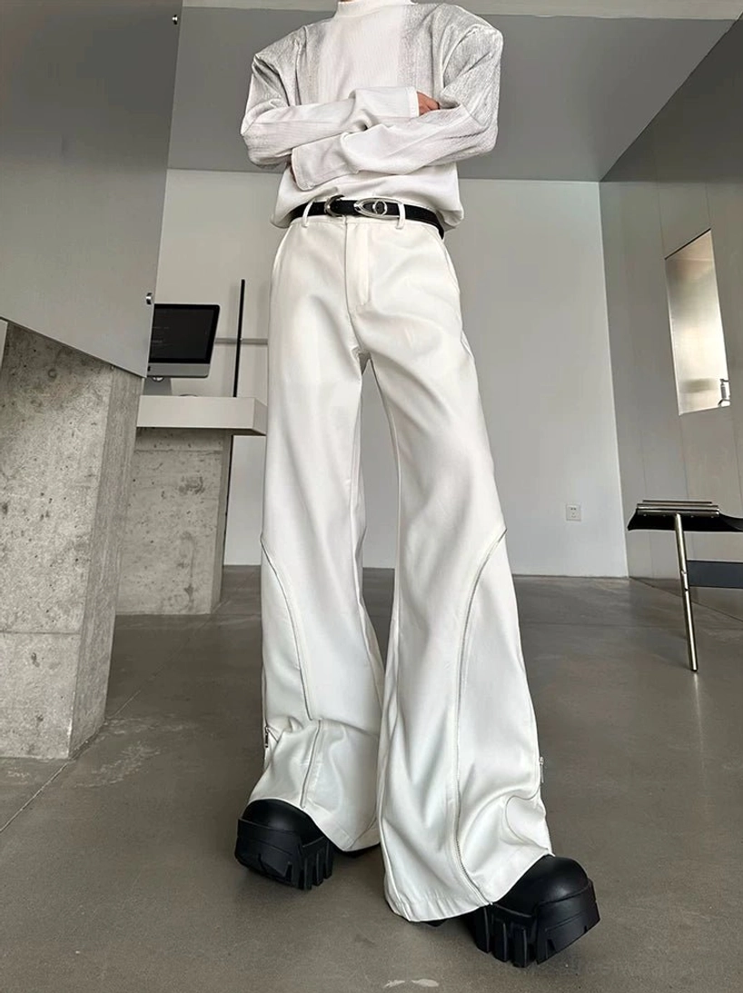 Off-white Orbit Sculpt wide-leg zip trousers shown from a low-angle front view with curved side seams, silver zipper trim, high waist, and ultra-long draped legs over chunky footwear