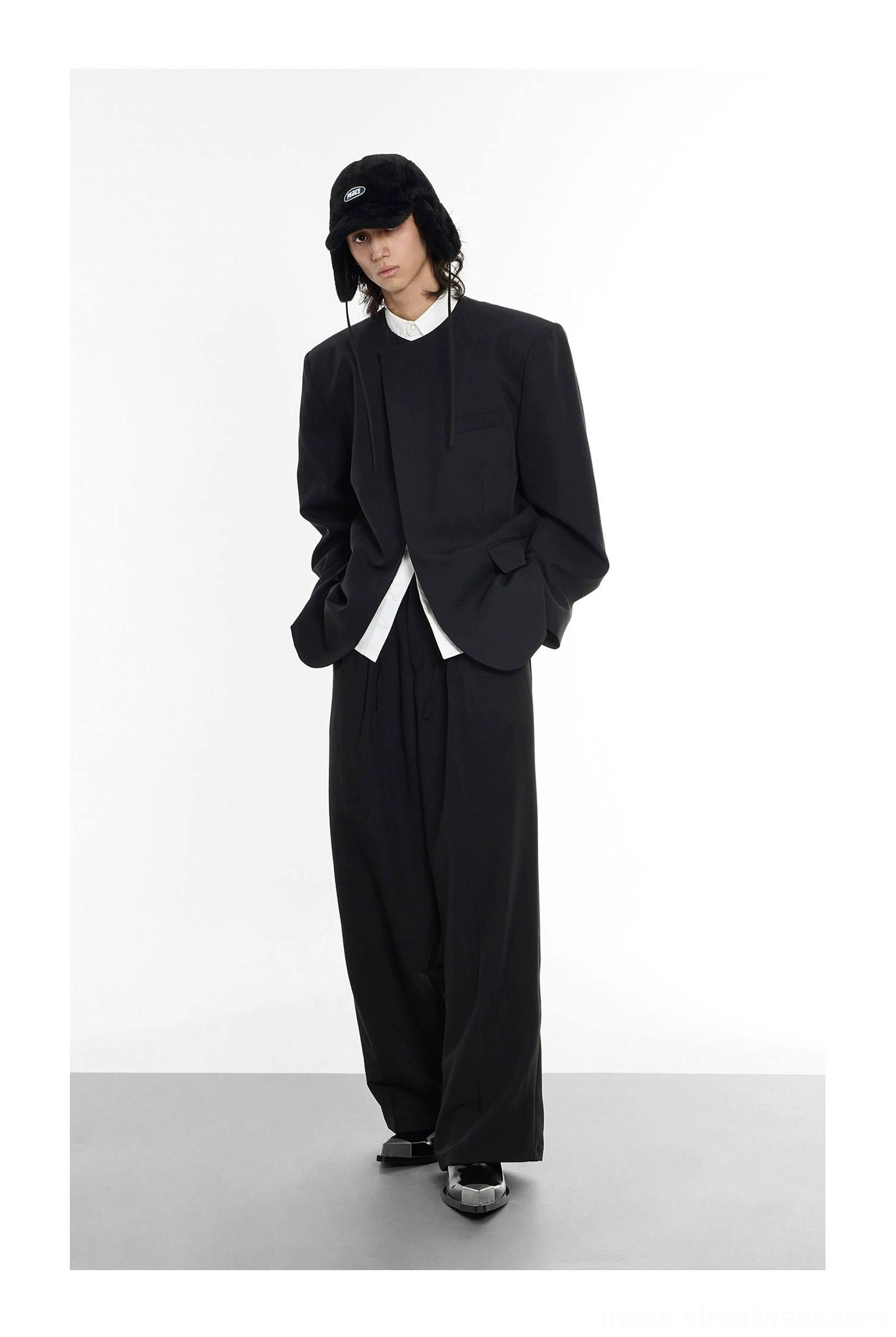 Oversized black collarless blazer layered over white shirt hem for Korean streetwear outfit