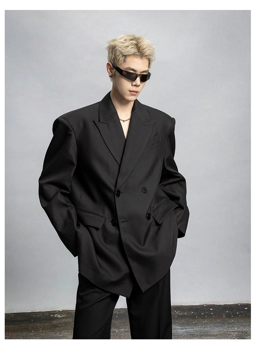 Front three-quarter view of oversized black double-breasted blazer showing padded shoulders wide lapels and flap pockets