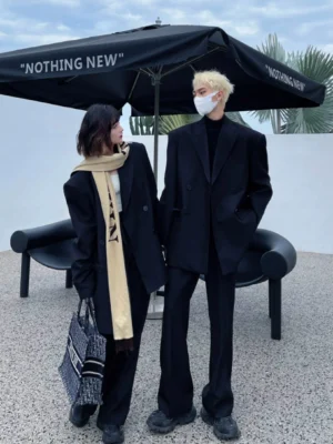Oversized black double-breasted blazer styled in a coordinated Korean streetwear outfit in an outdoor urban setting