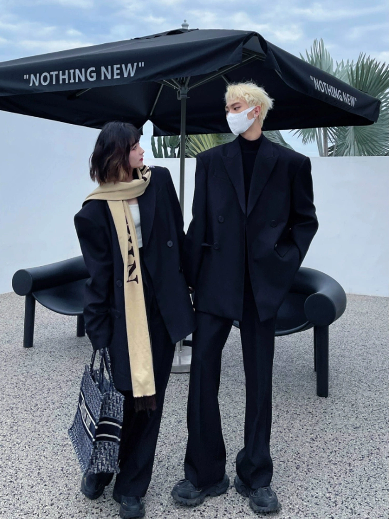 Oversized black double-breasted blazer styled in a coordinated Korean streetwear outfit in an outdoor urban setting