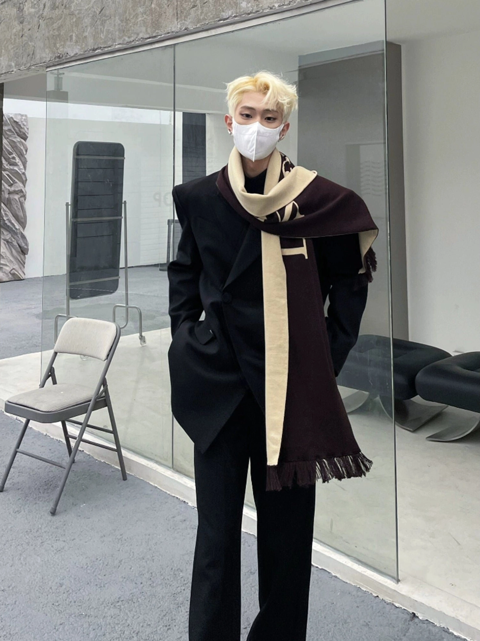 Oversized black double-breasted blazer with wide-leg trousers and fringe scarf for Seoul-inspired streetwear styling