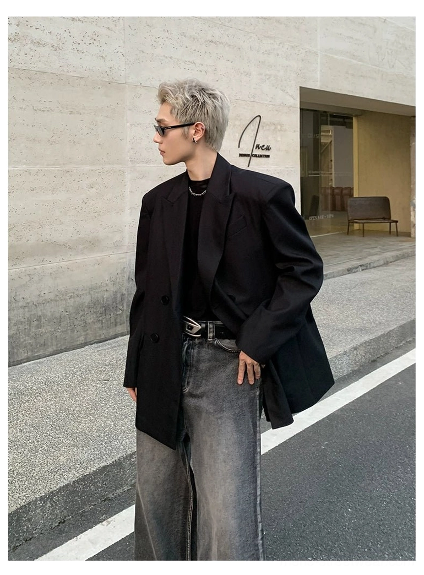 Black oversized double-breasted blazer featuring wide lapels padded shoulders and flap pocket tailoring