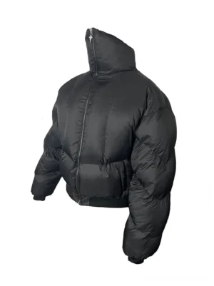 Front product view of an oversized black down puffer jacket with channel quilting cropped bomber length and high stand collar