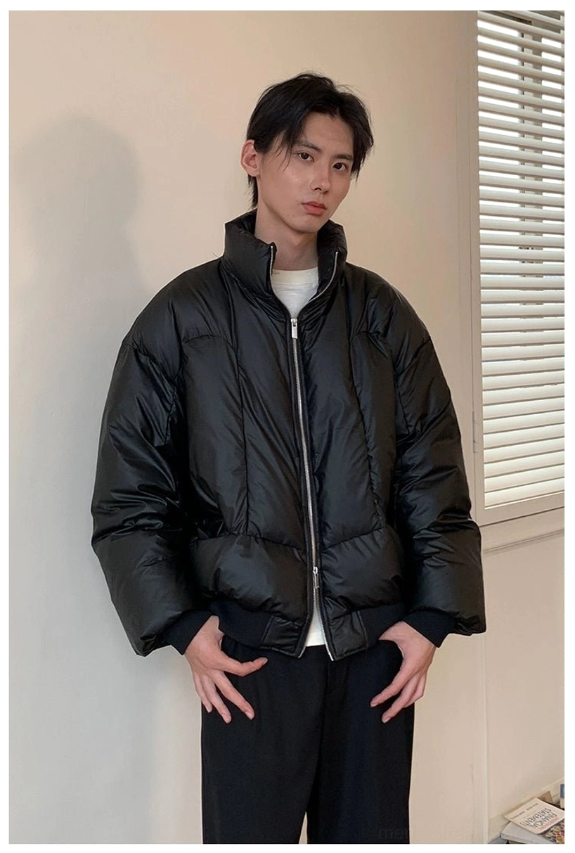 Full body front view of oversized black duck down puffer jacket with clean quilted stitching and relaxed winter fit