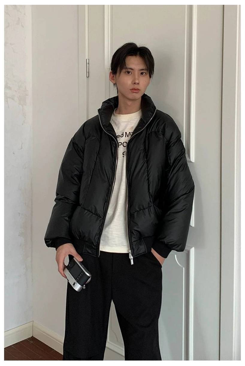 Oversized black duck down puffer jacket with glossy nylon shell and ribbed trim winter outerwear detail