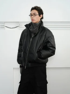 Oversized black duck down puffer jacket with stand collar and glossy quilted nylon front view on male model