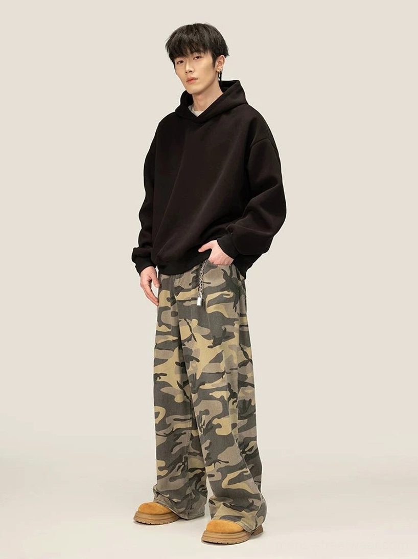 Side view of oversized black pullover fleece hoodie with ribbed cuffs and relaxed streetwear silhouette