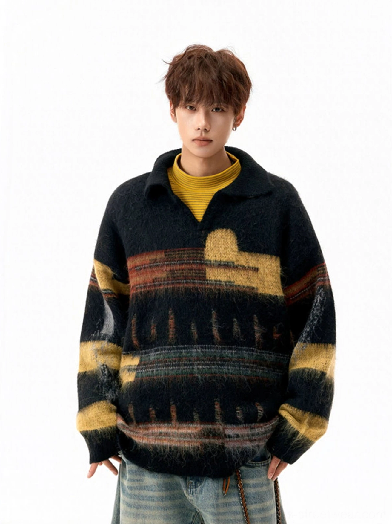 Front view of an oversized retro black fuzzy knit sweater with abstract colorblock pattern layered over a yellow turtleneck
