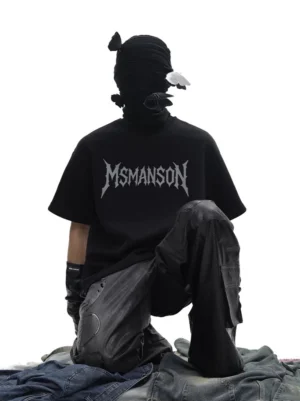 Relaxed back view of oversized black cotton gothic logo T-shirt with washed dark denim and underground streetwear styling