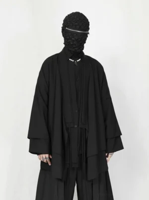 Front view of oversized black kimono cardigan with wide layered sleeves, wrap front, pearl necklaces, and Korean streetwear styling