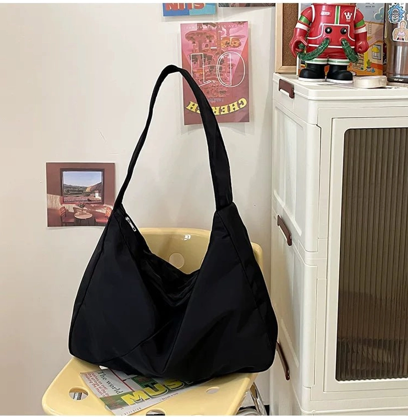 Oversized black nylon city sling bag for Korean streetwear with spacious minimalist everyday carry design