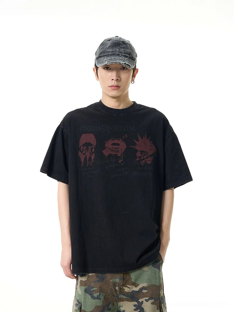 Front full body view of an oversized black punk graphic tee with maroon distressed print styled with camo cargo pants and a washed denim cap