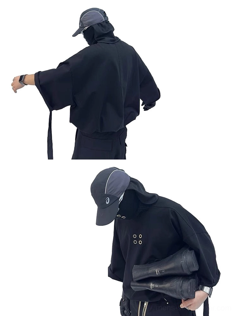 Back three-quarter view of oversized black streetwear T-shirt showing long relaxed fit and side hanging strap