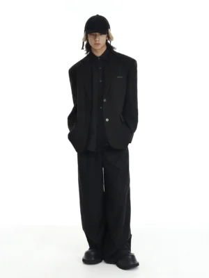 Black oversized two-button blazer styled with matching wide-leg trousers in a clean minimalist streetwear outfit