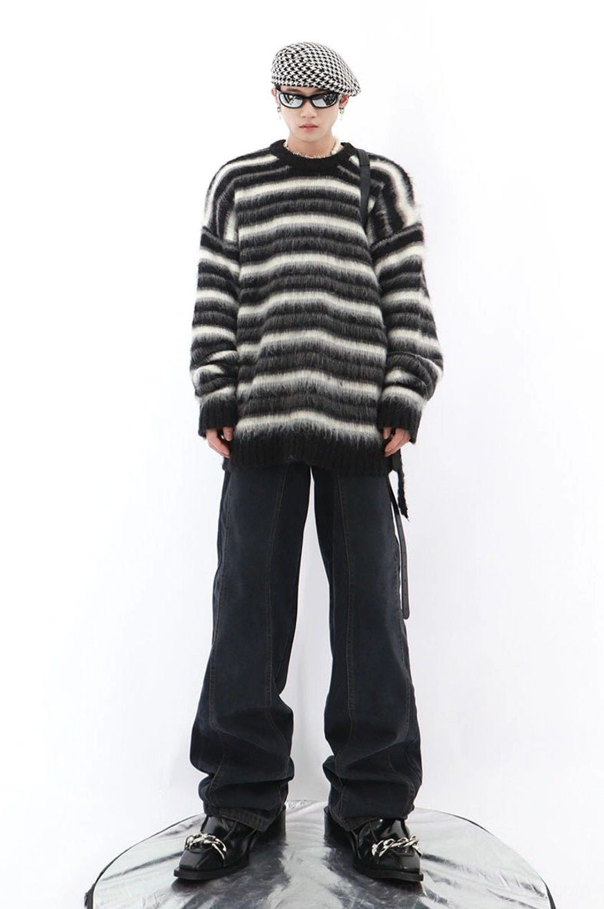 Full body Korean streetwear outfit featuring oversized black and white striped mohair blend sweater with wide leg jeans