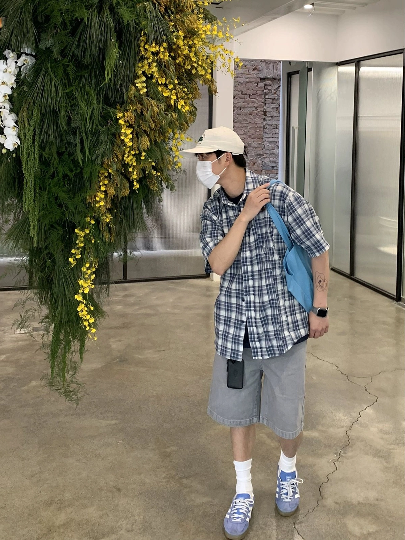 Oversized blue white plaid short sleeve shirt in Korean casual streetwear styling with tote bag and cap