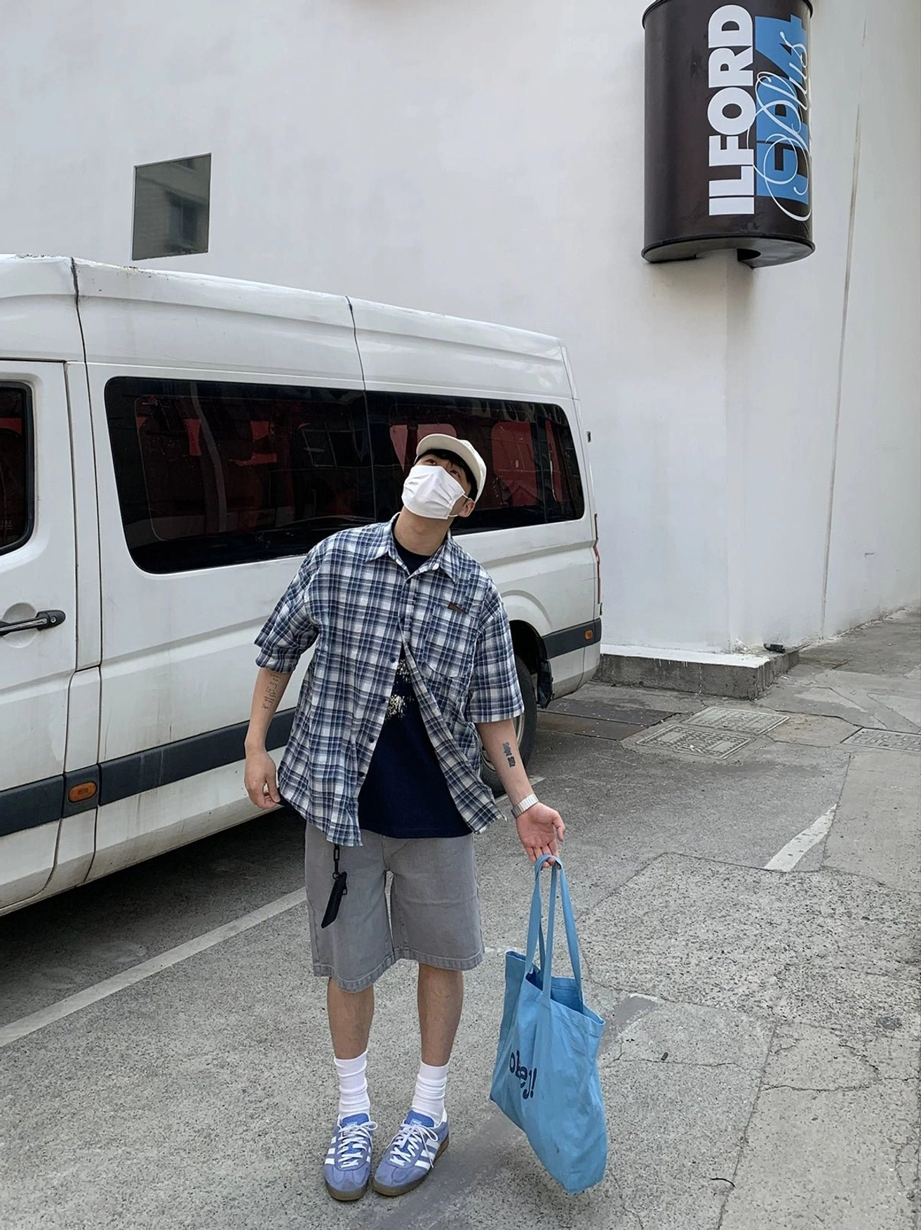 Side back view of oversized blue and white plaid Korean streetwear shirt showing relaxed loose silhouette