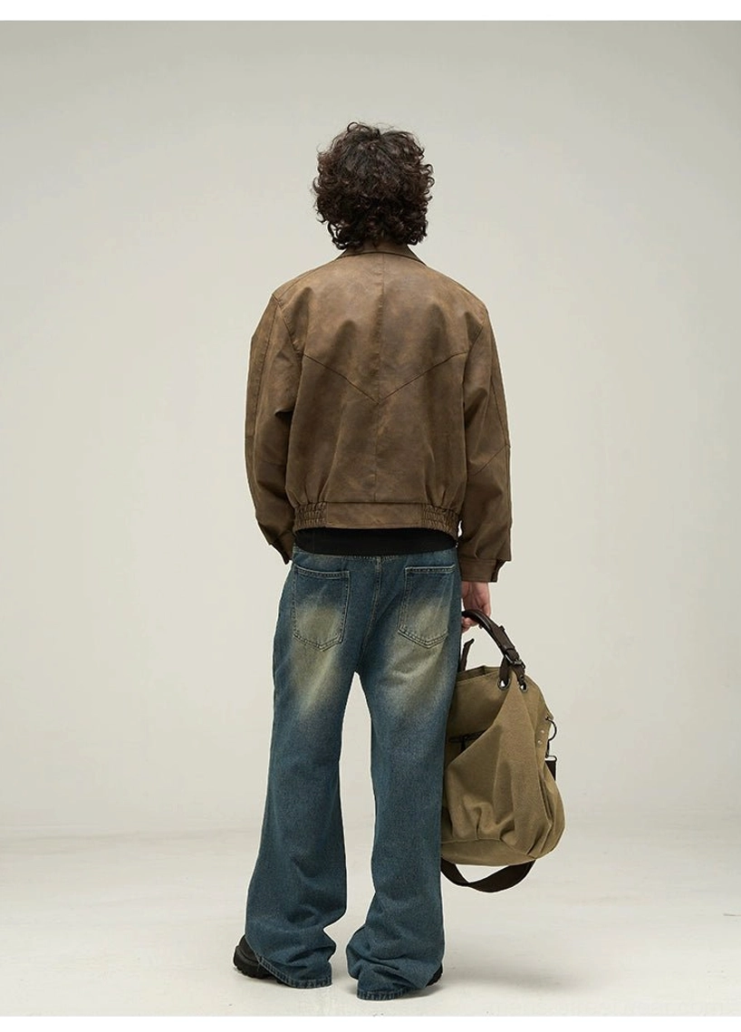Back view of an oversized brown faux leather streetwear jacket showing back yoke seams and elasticated ribbed waist hem