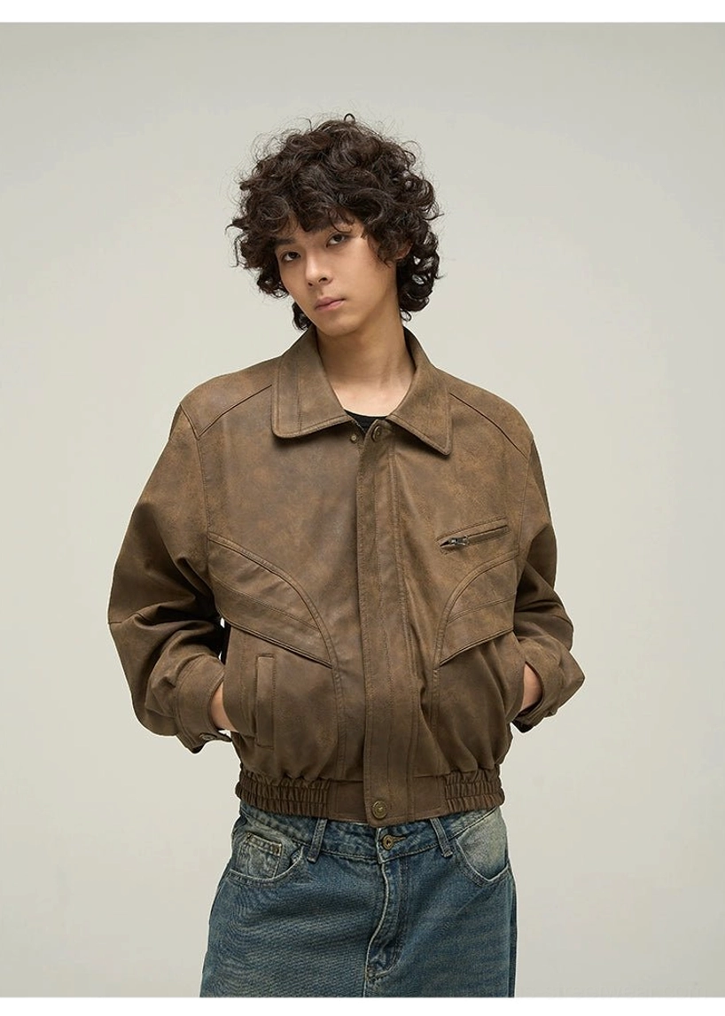 Front detail of a relaxed oversized brown faux leather jacket with dual flap pockets, chest zipper pocket, and vintage texture