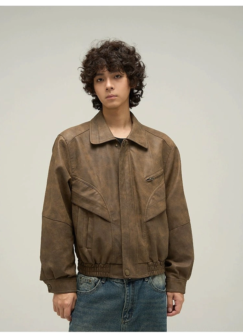 Close-up of an unbuttoned oversized brown faux leather jacket showing inner lining, long sleeves, and neat cuffs
