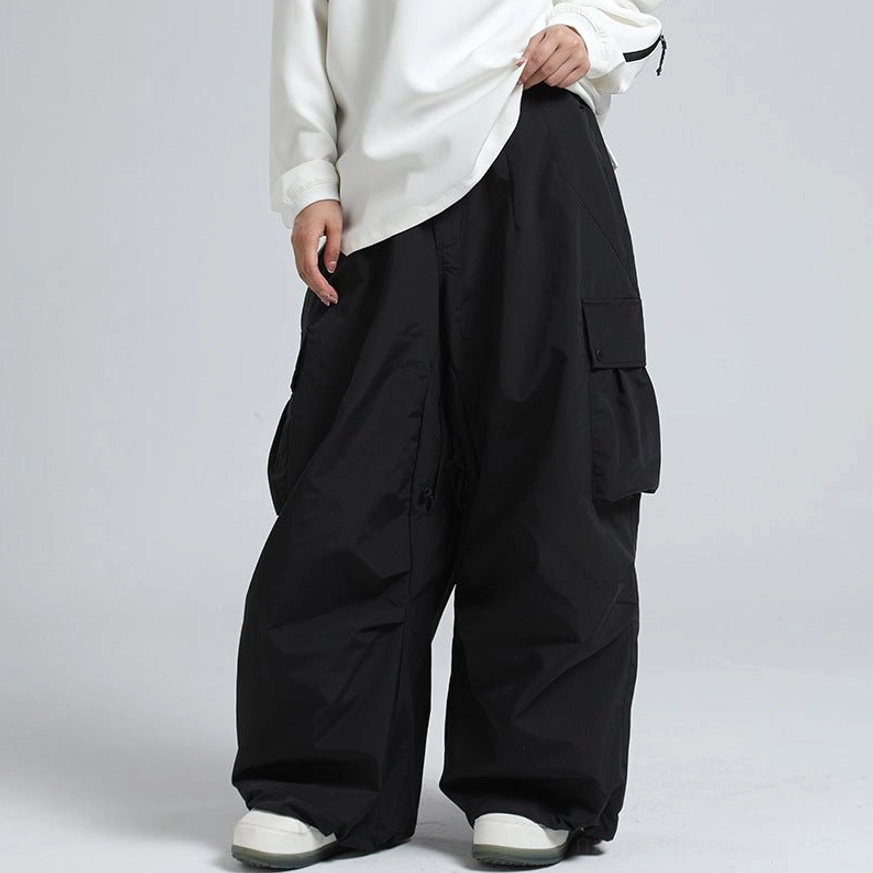 Black oversized wide-leg cargo snow pants styled with casual sneakers for modern streetwear