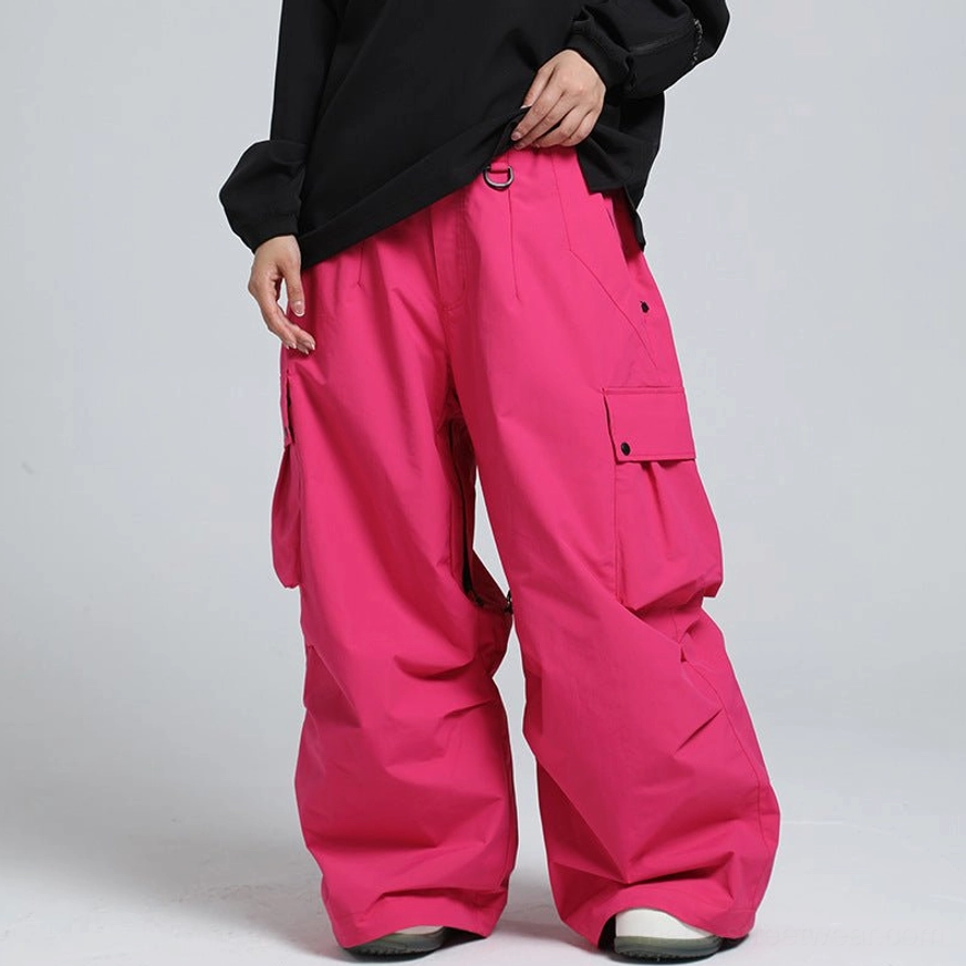 Hot pink oversized cargo snow pants with bold wide-leg fit and flap utility pockets