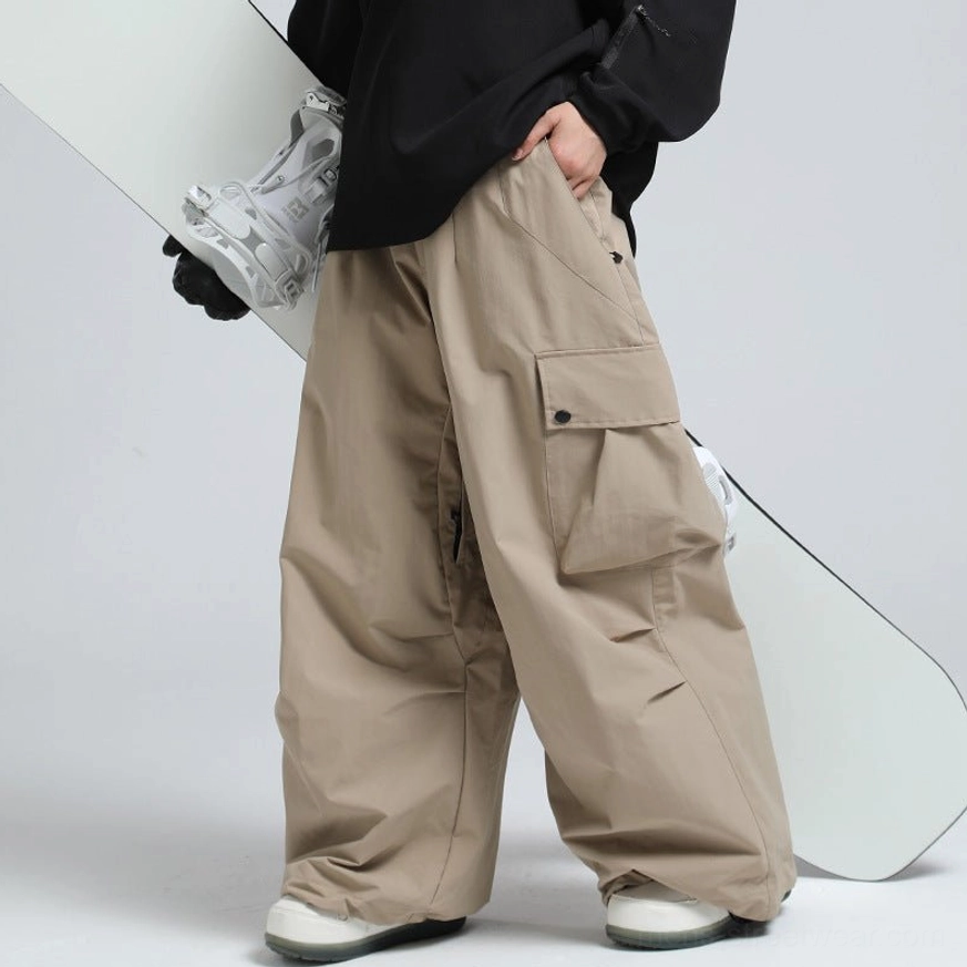 Khaki oversized cargo snow pants with wide-leg silhouette and snowboard-inspired outdoor styling