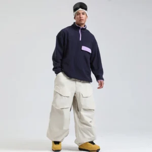 Off-white oversized cargo snowboard pants with wide-leg techwear fit styled with navy fleece and yellow ski boots