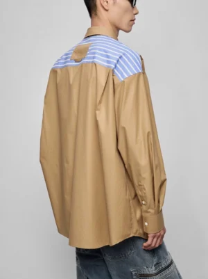 Back view of an oversized Korean streetwear patchwork shirt showing the matching blue and white striped back yoke and relaxed silhouette