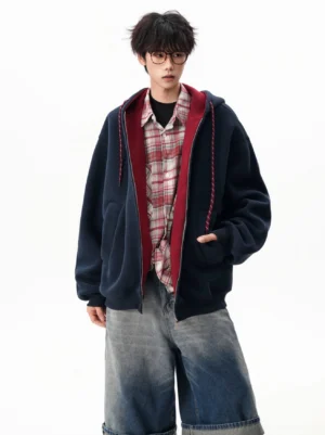 Oversized contrast color block zip-up hoodie styled with a plaid shirt and wide denim shorts in a relaxed Seoul streetwear outfit