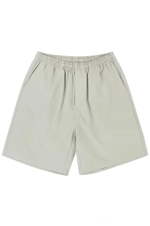 Front flat lay of light khaki grey oversized cotton beach shorts with elastic waist and loose straight five-point Korean streetwear fit